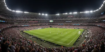 Aerial view of a brightly lit MLS stadium at night with a large crowd, representing the league's growing prominence.