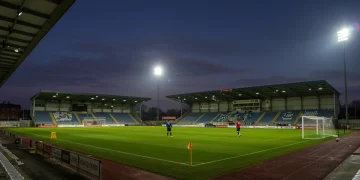 Soccer player in action on a floodlit stadium pitch during an MLS match.