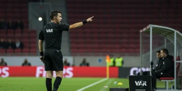 Referee using VAR monitor during a European football match