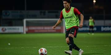 Young soccer player dribbling in an academy, focused on the ball